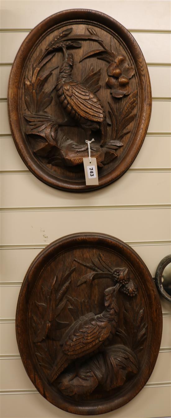 A pair of oval carved plaques, H.50cm